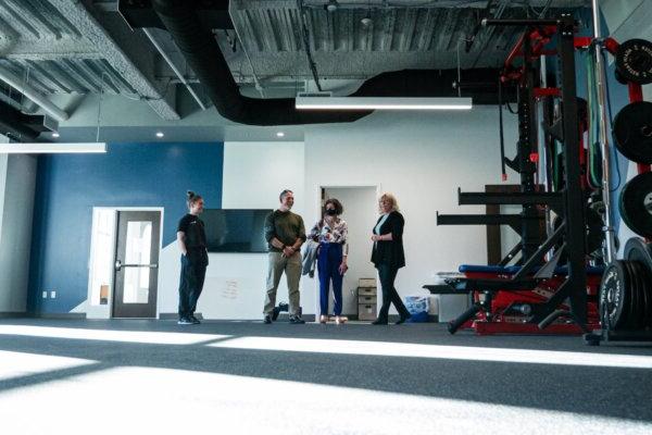 People stand inside a fitness space in Shenandoah University's new Wilkins Health & Fitness Suite.